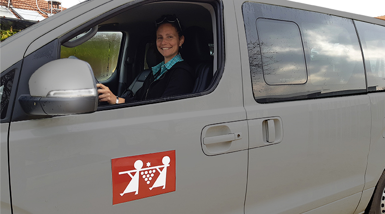 Rotem driving a grey car as both driver and licensed tour guide in Israel